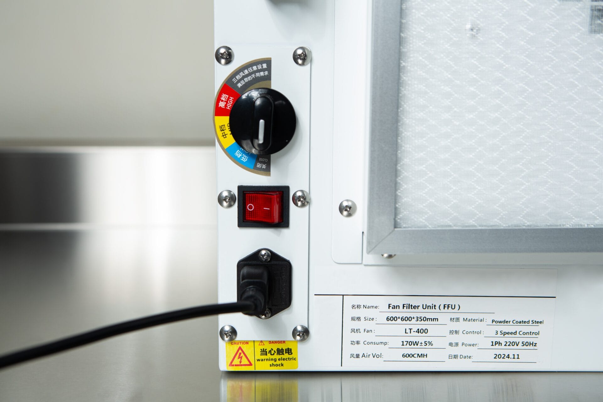 Close-up of the Laminar Flow Hood HEPA Airfilter H14 with prefilter 60x60x35cm control panel, showing warning labels, knobs, switches, and a connected power lead.