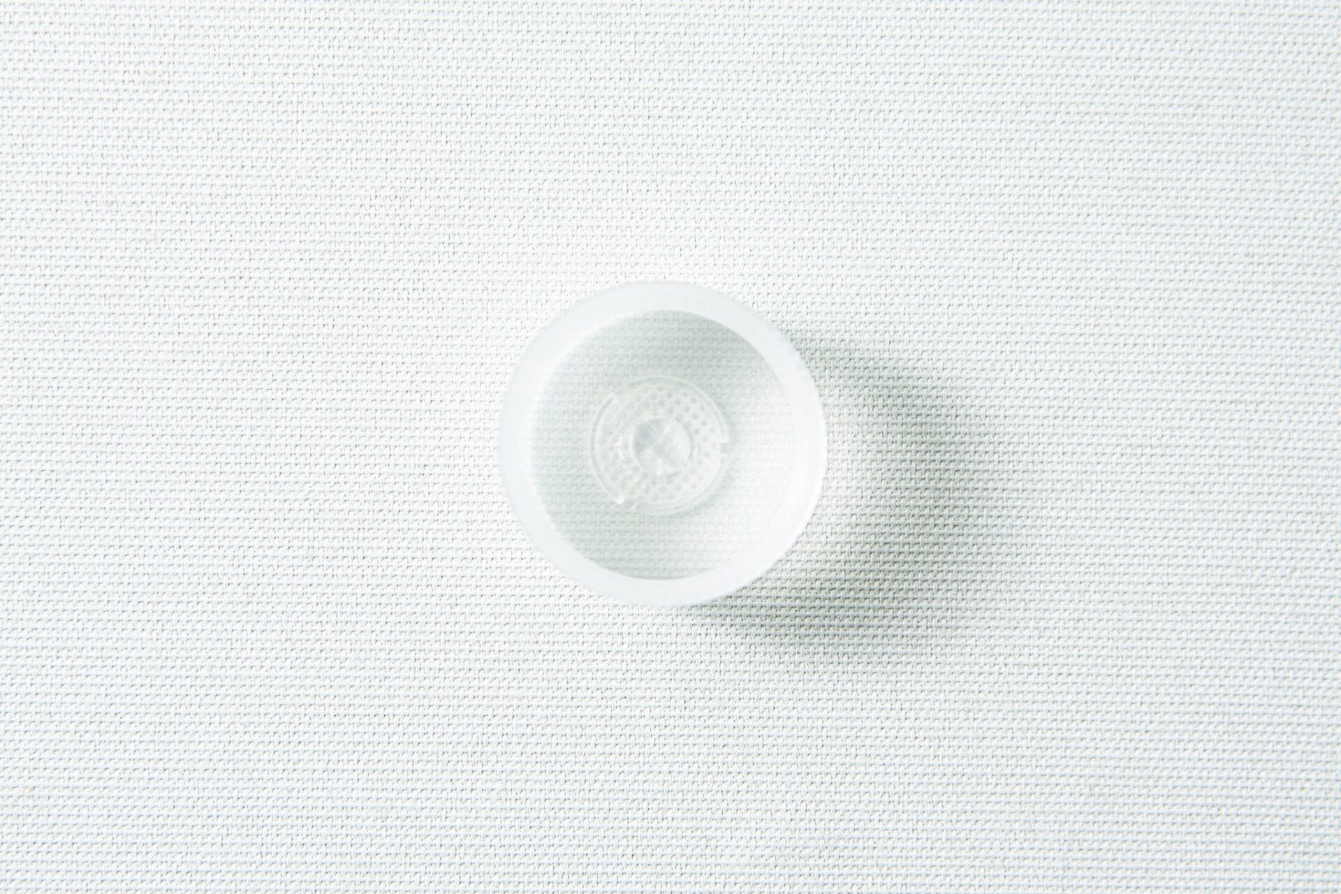 The Plant Cell Vented Plant TC Test Tubes with rack 12pc set shown from above, featuring a clear suction cup on a white textured surface.