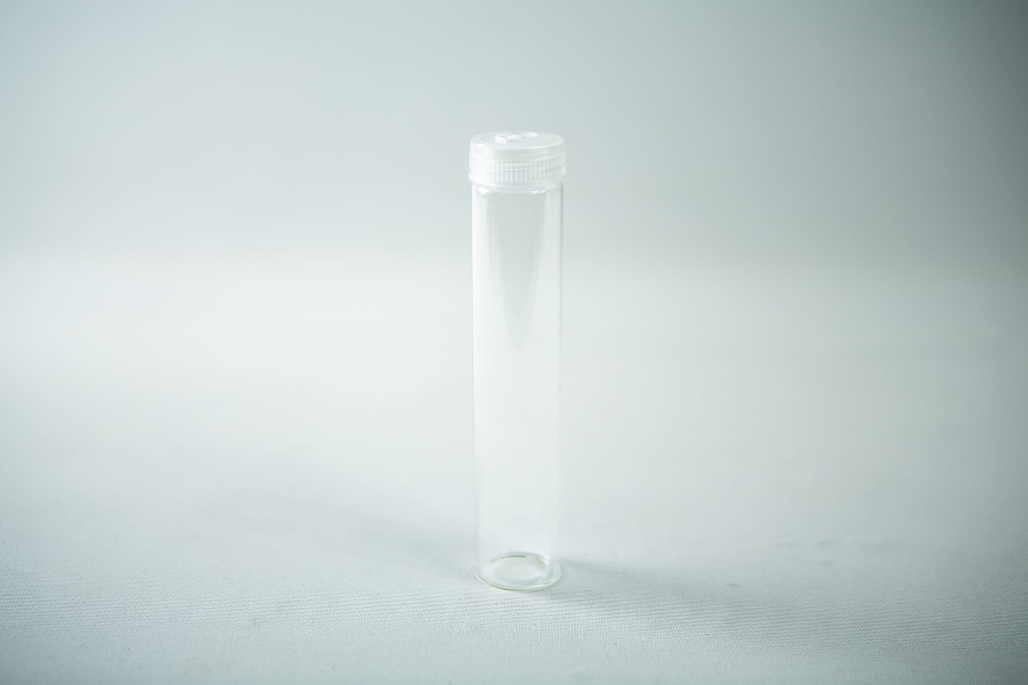 A set of Plant Cell Vented Plant TC Test Tubes with white screw caps, shown upright on a light surface in their rack; comes as a 12-piece set.