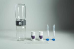 A water testing kit with bottles, vials, dropper, and containers on a grey background—ideal for use with your Plantcell Synthetic Seed Starter Kit to ensure optimal hydration and healthy plant growth.
