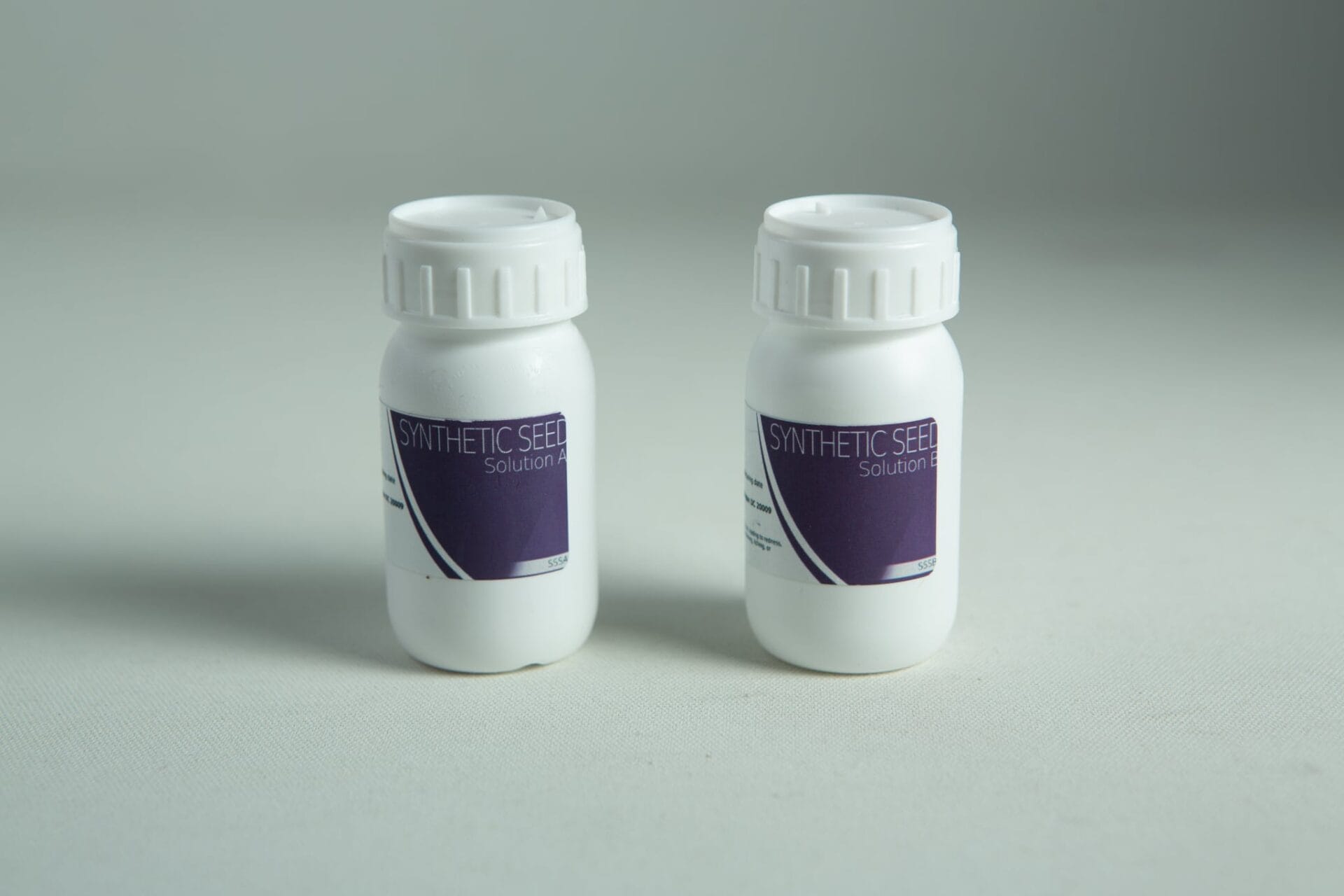 Two white bottles labelled Solution A and Solution B from the Plantcell Synthetic Seed Starter Kit are displayed on a light background.