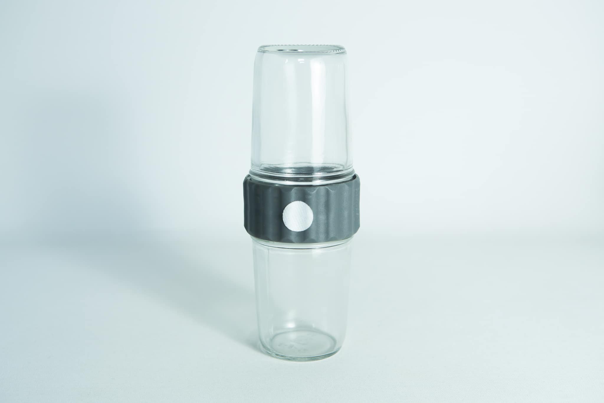 Two clear Plant Cell Biocoupler™ Glass Set cups (16oz, 12oz) are stacked with a black and white band around the middle, shown against a white background.