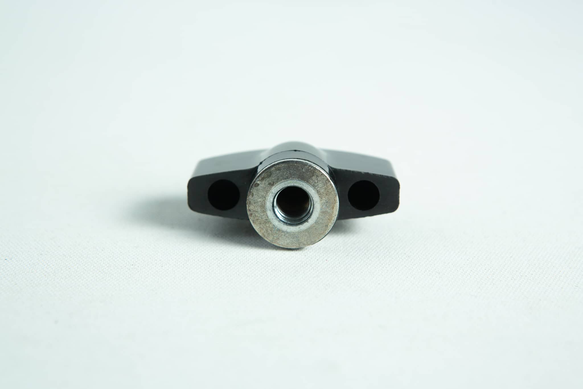 The All American Wingnut, made of black metal with a central circular hole, is shown from the front on a plain white background.