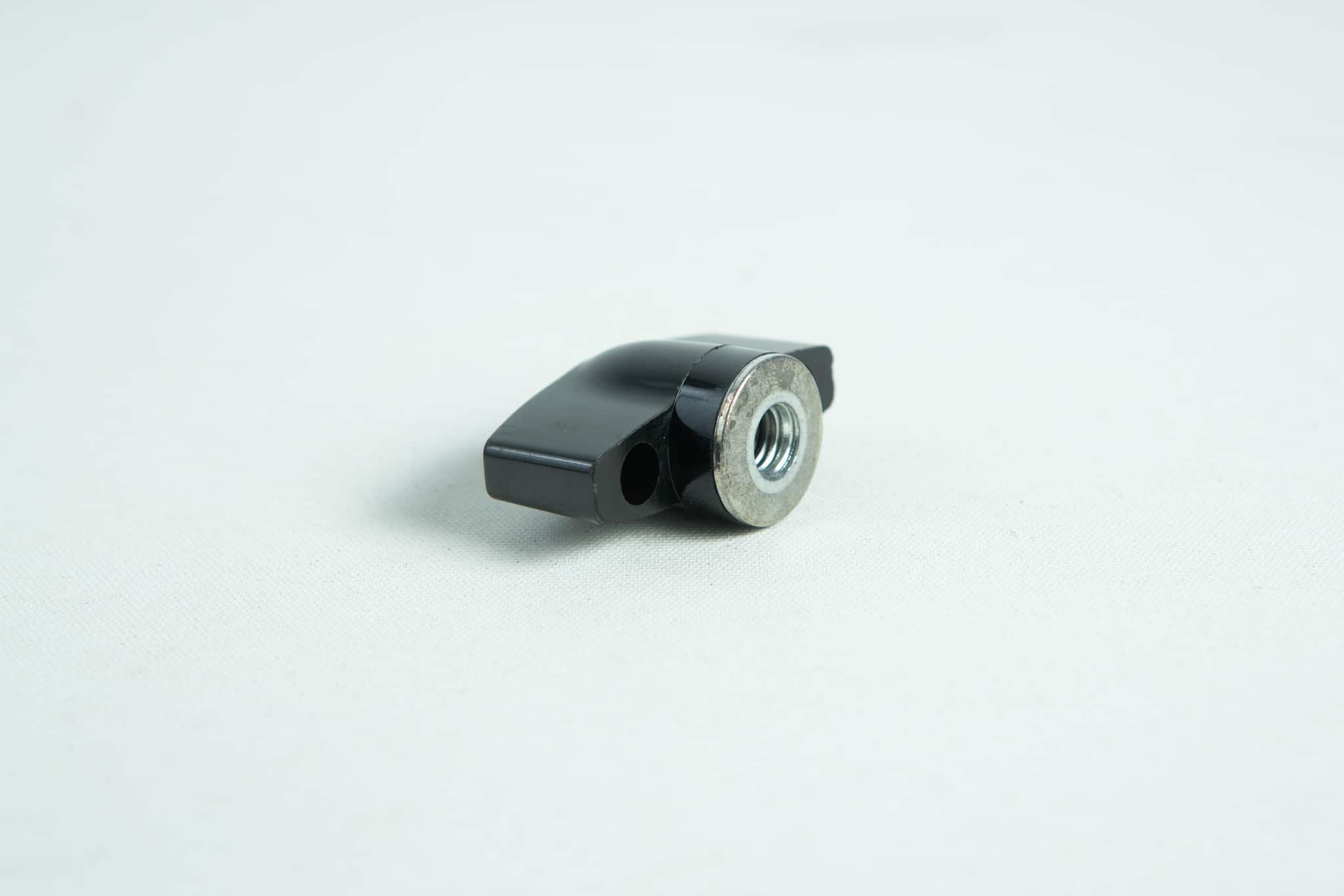 The All-American Wingnut is a black metal lever with a threaded hole, displayed on a plain white surface.