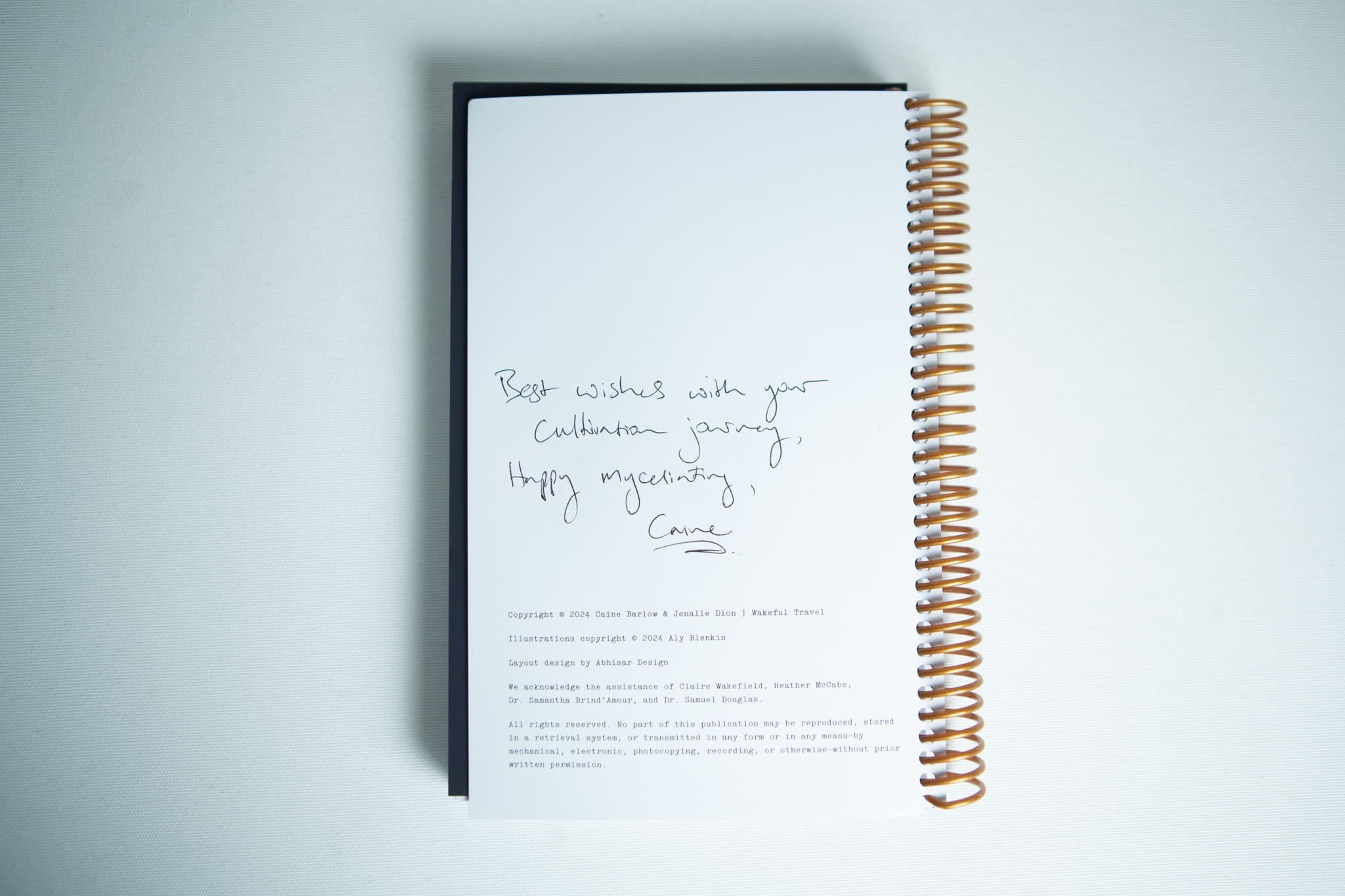 The Wakeful Mushroom Cultivation Journal by Australian mycologist Caine Barlow, featuring a handwritten message: Best wishes with your cultivation journey. Happy myciliating, Caine.