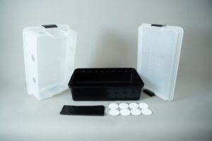 Plastic mushroom growing kit with a black tray, Colonisation Lid, two clear lids, filter discs, and a black filter patch—ideal for growing mushrooms at home.