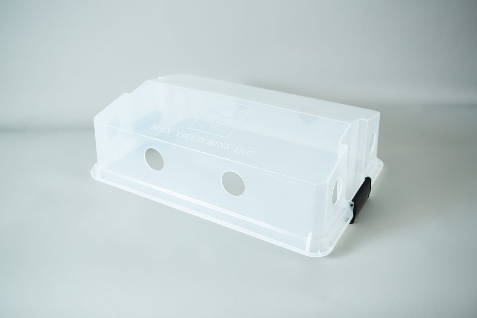 Clear plastic box with circular holes and a black handle, perfect as a monotub kit for growing mushrooms, on a plain white background.