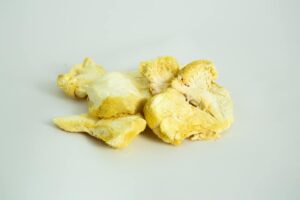 Slices of Freeze-Dried Mushroom Lion’s Mane displayed on a plain white background.