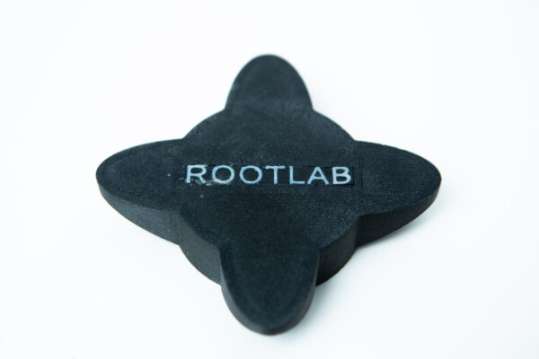 A black, four-pointed object with ROOTLAB written on it, placed on a white background.