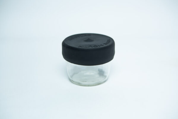 A wide-mouthed glass jar with a silicone Mason jar rubber lid in sleek black, displayed on a white background.