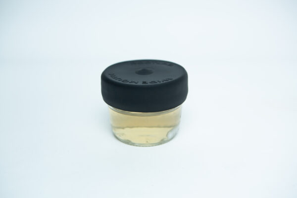 Silicone Jam Jar Rubber Lid (Wide Neck) on a clear glass jar with pale yellow liquid, shown against a plain white background.