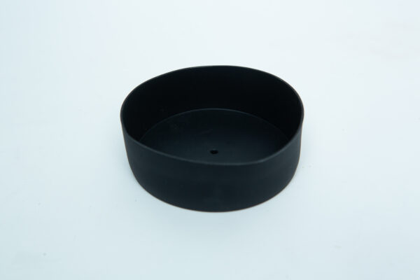 The Silicone Mason Jar Lid Cover is a black, round plastic accessory with a centre hole, designed for wide-mouth jars. It pairs seamlessly with the autoclavable silicone mason jar lid and is shown on a white background.
