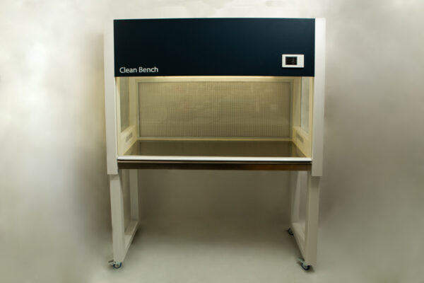 A laboratory clean bench with a glass work surface and overhead lighting, on four castors.