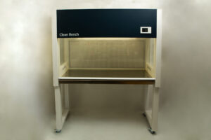 A laboratory clean bench with a glass work surface and overhead lighting, on four castors.