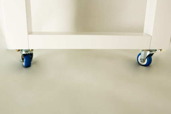 White metal frame with two blue castor wheels on a light-coloured floor.