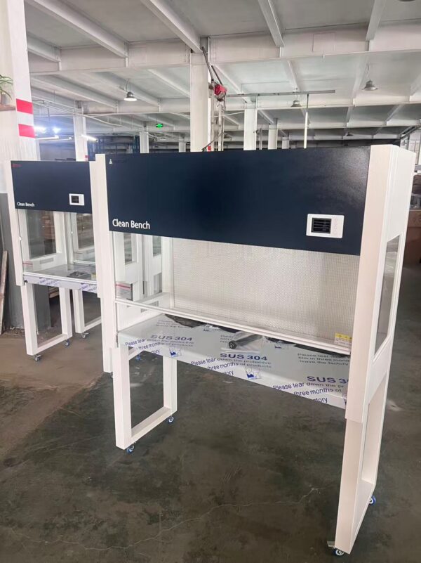 Two clean benches in a laboratory setting, with protective glass and HEPA filter visible.